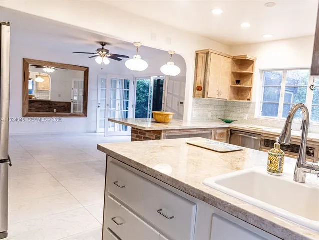 a kitchen with stainless steel appliances granite countertop a sink and a stove