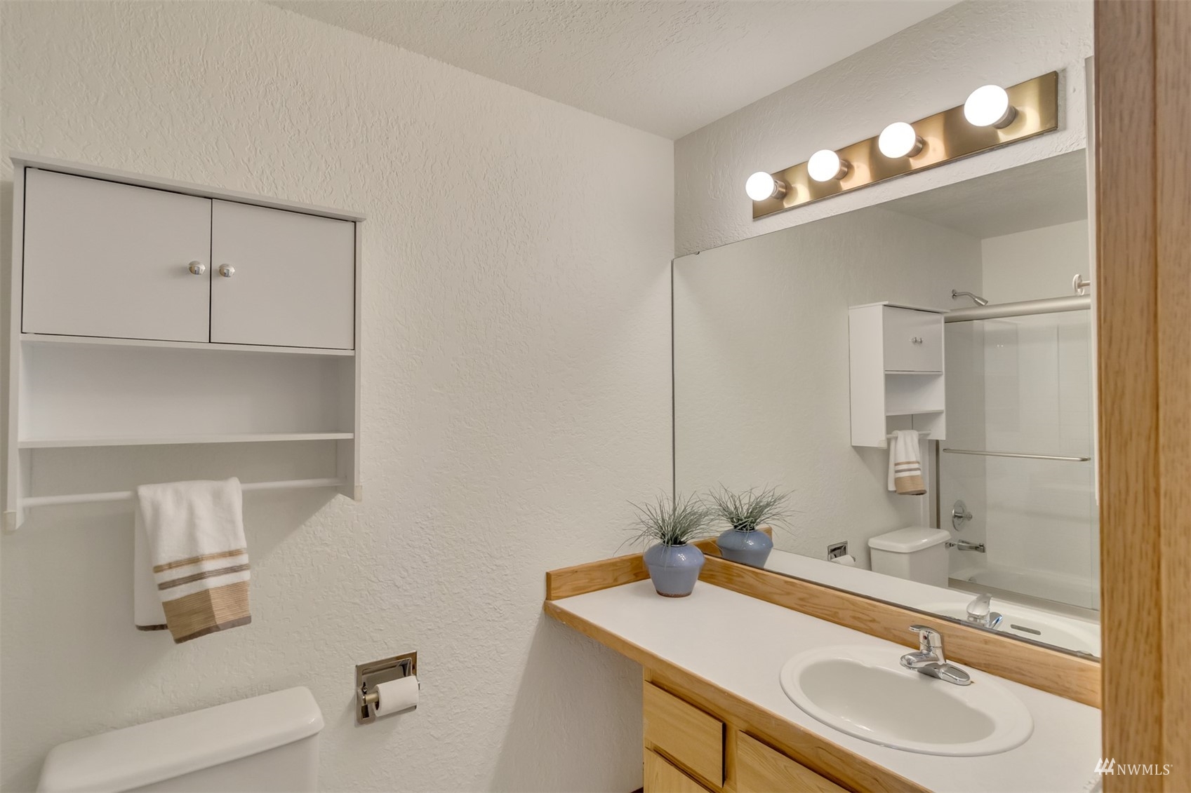 22420 13th Place West Bothell, WA 98021 - Photo 8 of 19 a bathroom with a sink a vanity a mirror and a toilet