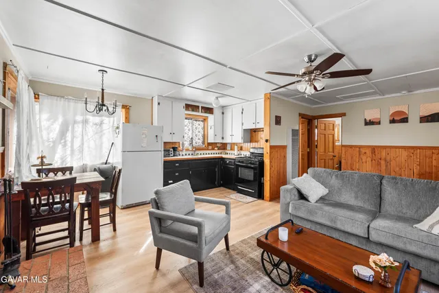 a living room with furniture and kitchen view