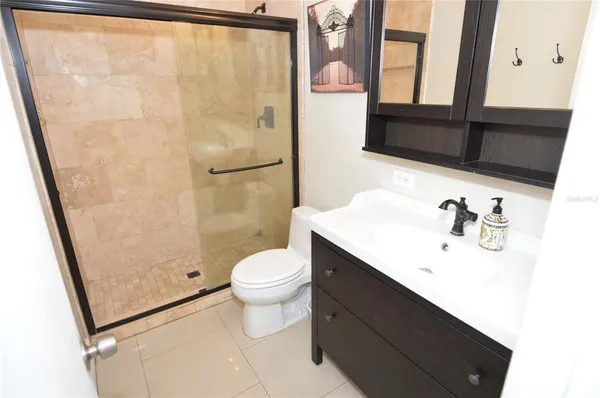 a bedroom with two beds and a chair