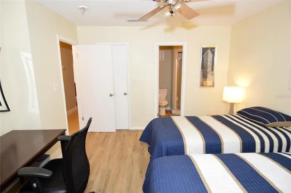 a front view of a house with a garden and fountain