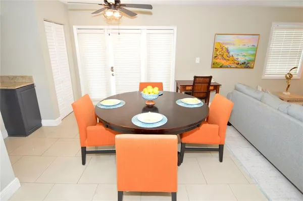 a kitchen with stainless steel appliances granite countertop a refrigerator and a wooden floor