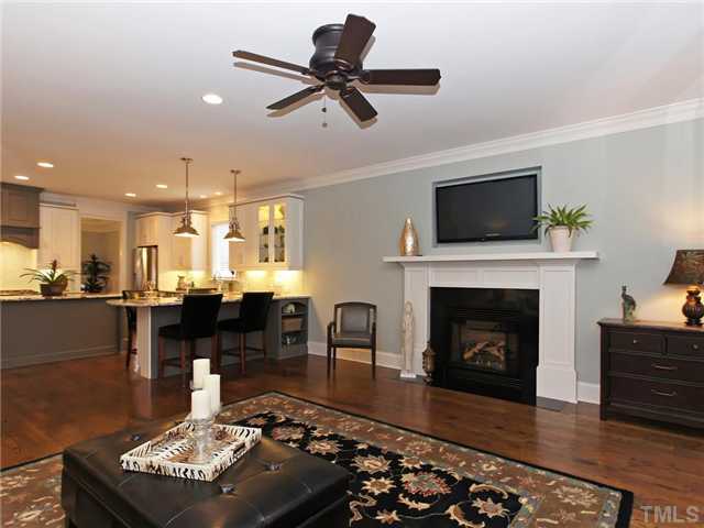 5227 Lansdowne Place Raleigh, NC 27609 - Photo 9 of 25 Family room features crown molding, built-in flat screen tv, hardwoods and gas logs.