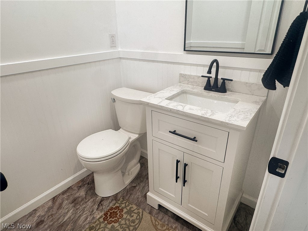 6666 Clingan Road Youngstown, OH 44514 - Photo 27 of 41 Half bathroom off the family room with new vanity, wainscoting, fixtures and flooring.