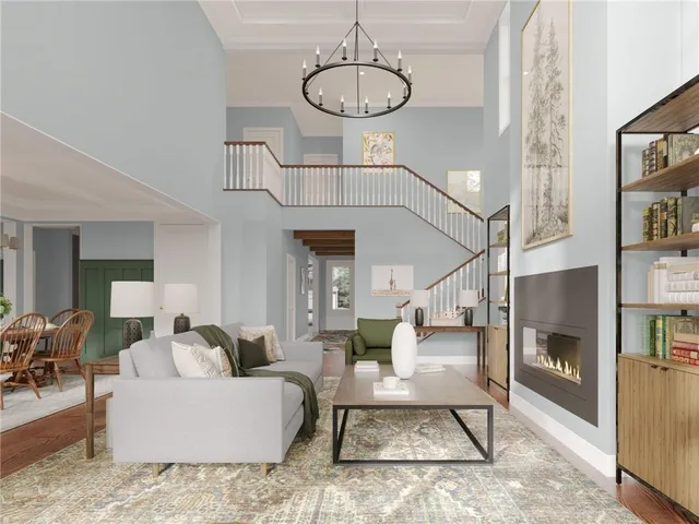 a living room with furniture a dining table and a chandelier