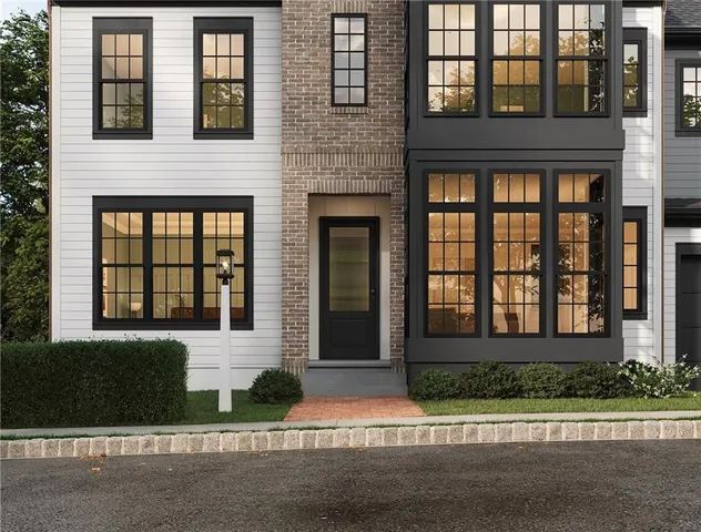 a front view of a brick house with a yard