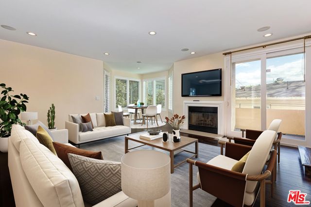 a living room with fireplace furniture and a flat screen tv