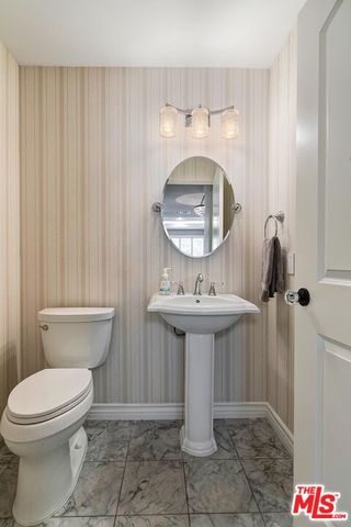 a large bedroom with a bed and a flat screen tv