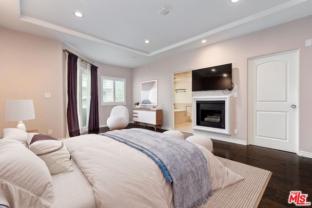 a spacious bedroom with a bed and couch