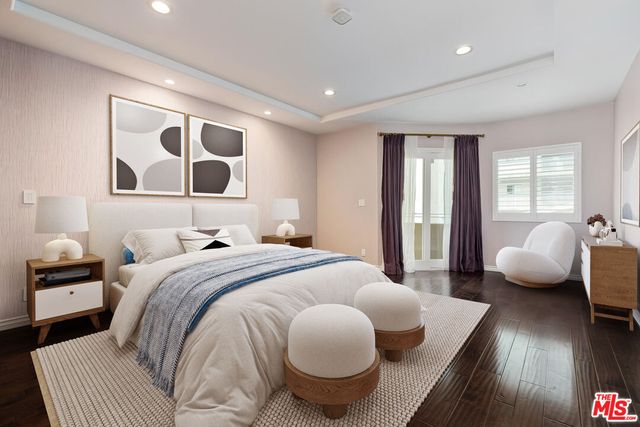 a spacious bathroom with a granite countertop sink a mirror a shower and a bathtub