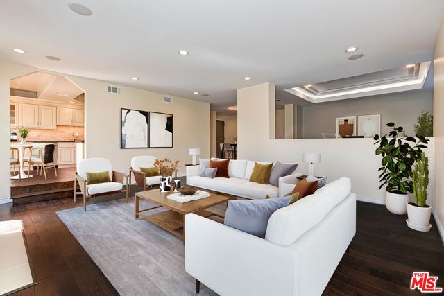 a living room with furniture potted plant and a window