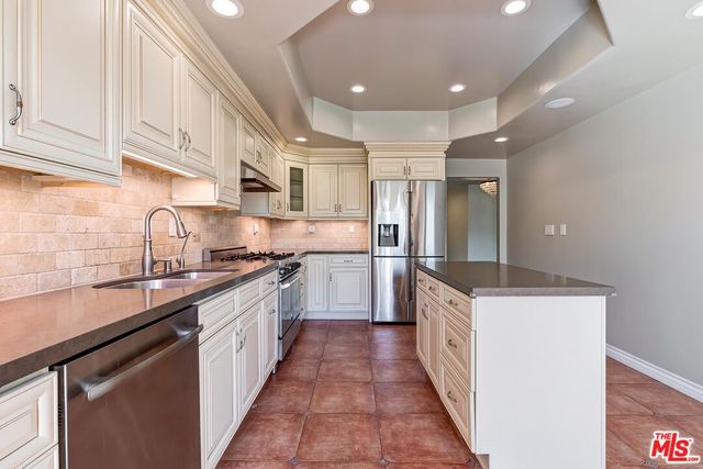 a kitchen with granite countertop a sink and cabinets