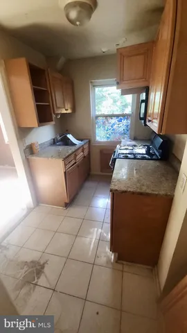 a kitchen with stainless steel appliances granite countertop a sink and a stove