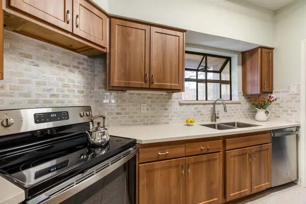 a kitchen with a sink stove and cabinets