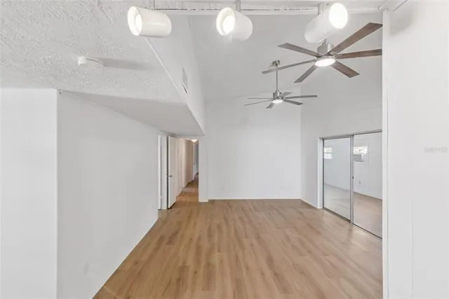 a view of empty room with wooden floor