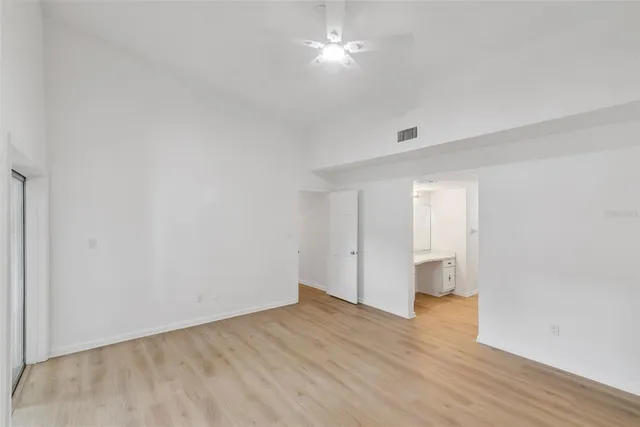 a view of empty room with wooden floor