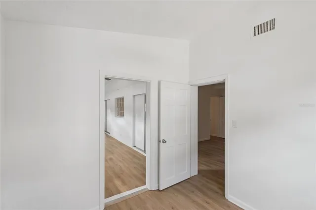 a view of hallway with wooden floor