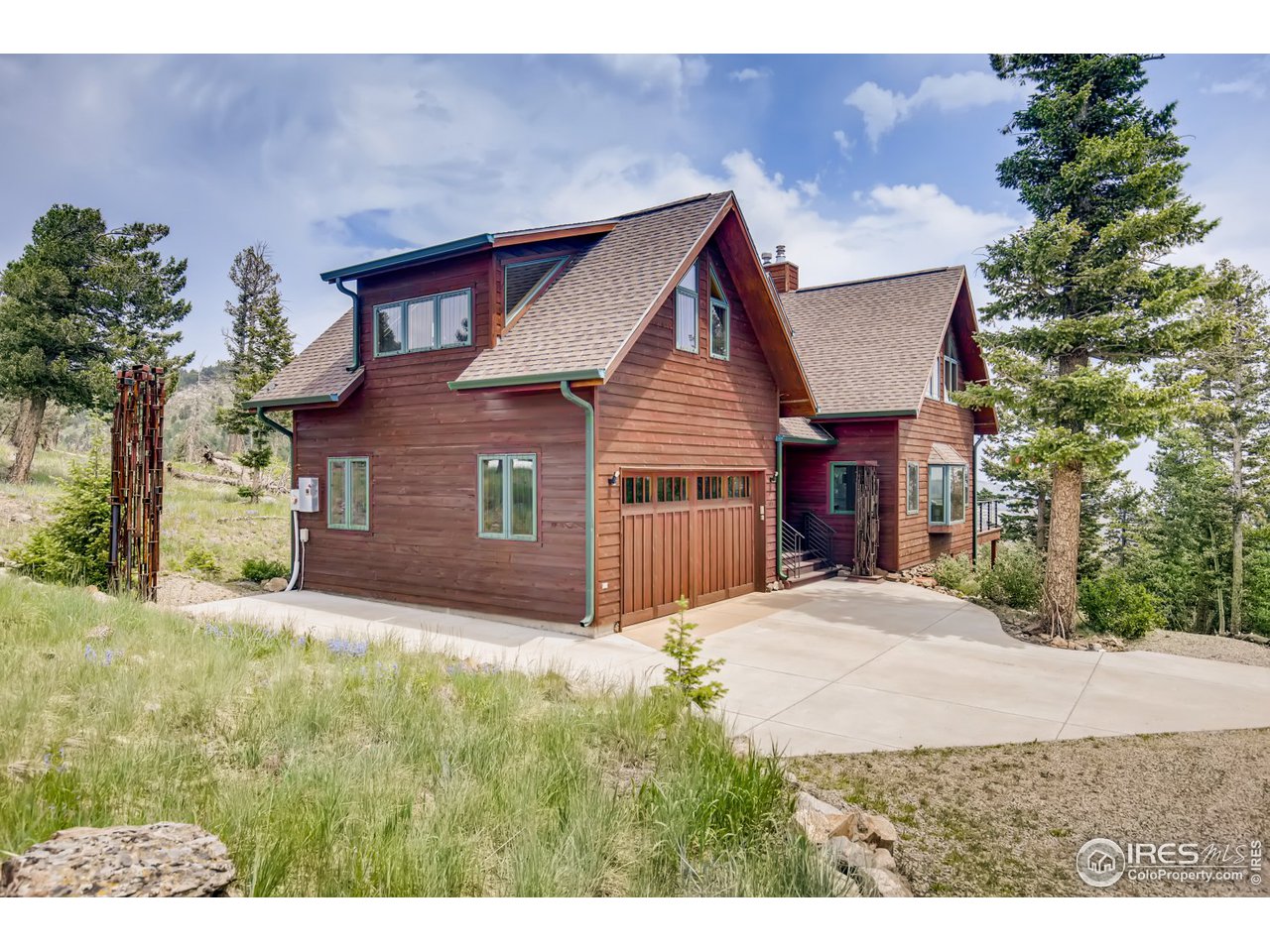a view of a house with a yard and potted plants