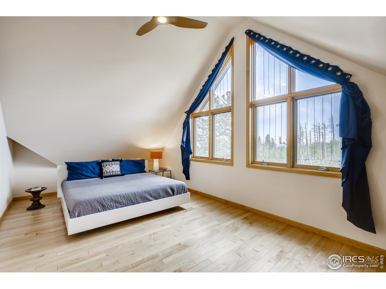 98 Rim Road Boulder, CO 80302 - Photo 11 of 31 a living room with a bed furniture and a large window