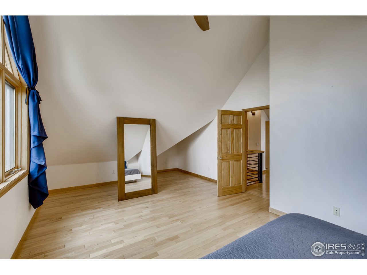 98 Rim Road Boulder, CO 80302 - Photo 12 of 31 a view of an empty room with wooden floor and a window