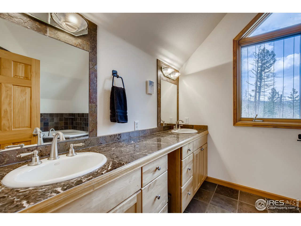 98 Rim Road Boulder, CO 80302 - Photo 13 of 31 a bathroom with a granite countertop sink and a mirror