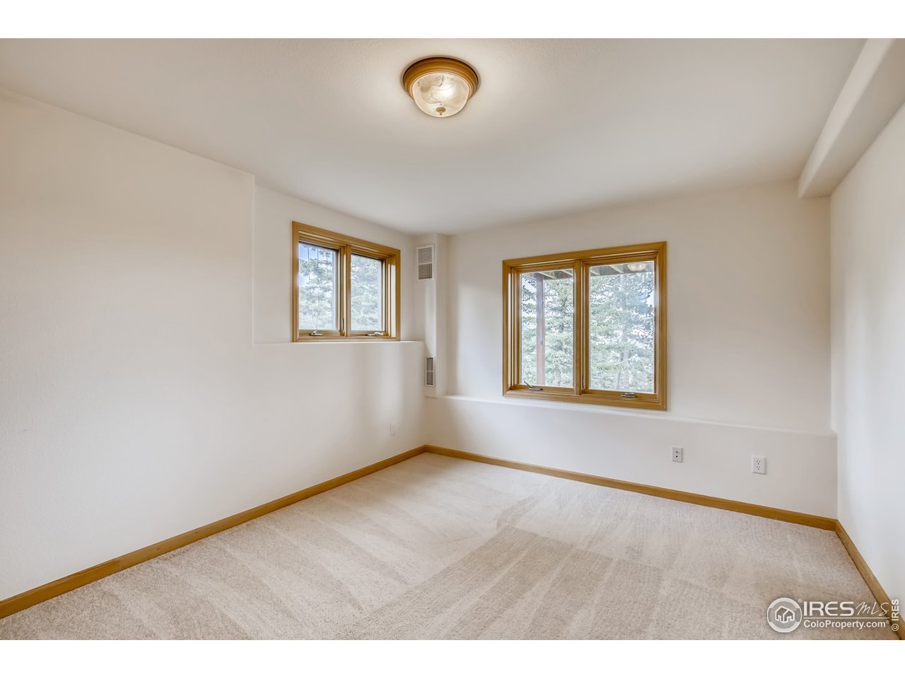 98 Rim Road Boulder, CO 80302 - Photo 18 of 31 an empty room with windows and entrance