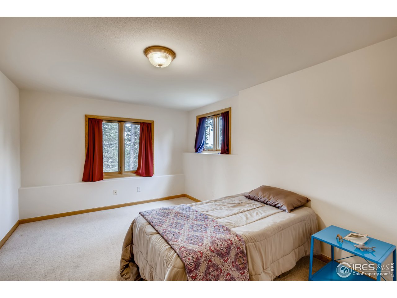 98 Rim Road Boulder, CO 80302 - Photo 19 of 31 a bedroom with a bed and a window