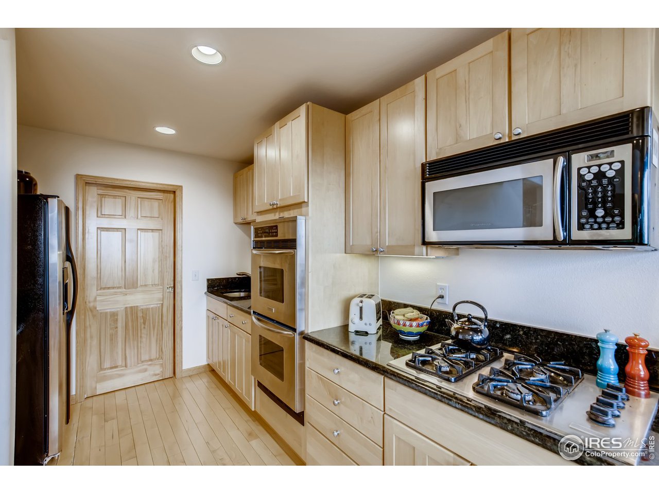 98 Rim Road Boulder, CO 80302 - Photo 8 of 31 a kitchen with stainless steel appliances granite countertop a stove a sink and a microwave