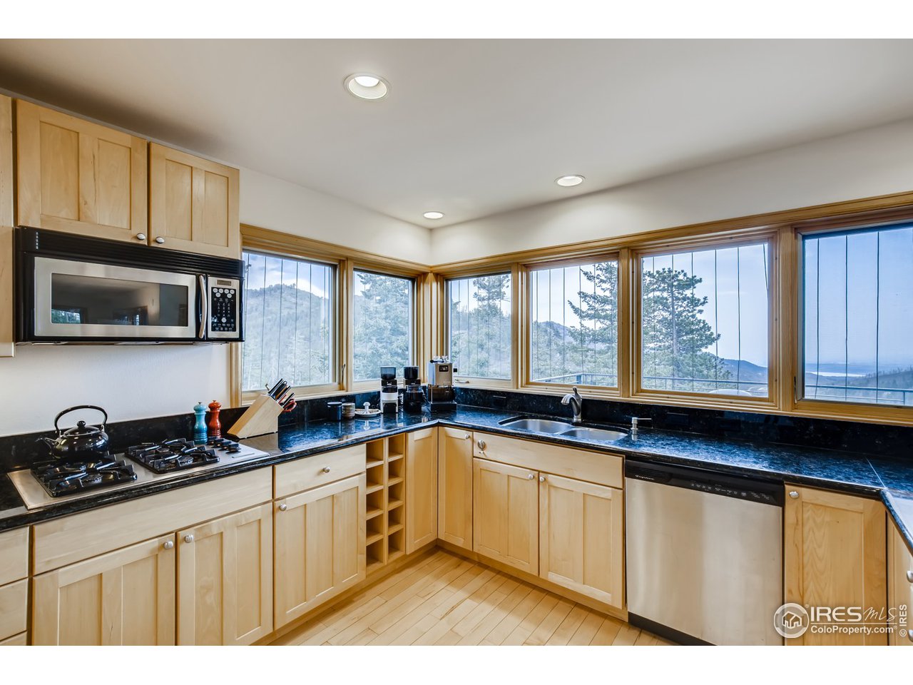 98 Rim Road Boulder, CO 80302 - Photo 9 of 31 a kitchen with stainless steel appliances granite countertop a sink a stove cabinets and a window