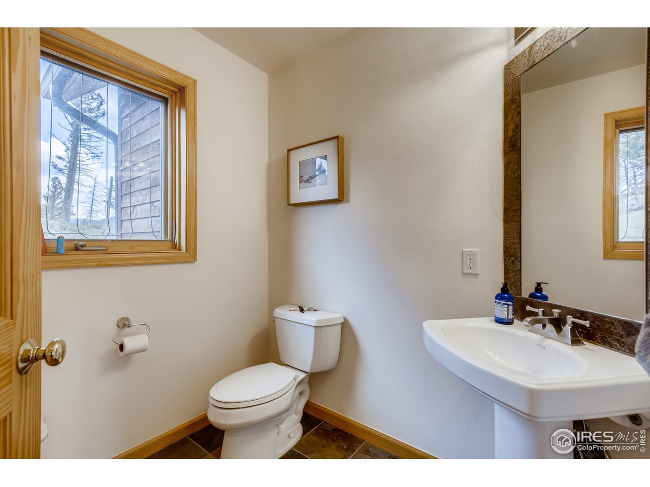 98 Rim Road Boulder, CO 80302 - Photo 10 of 31 a bathroom with a toilet sink and mirror