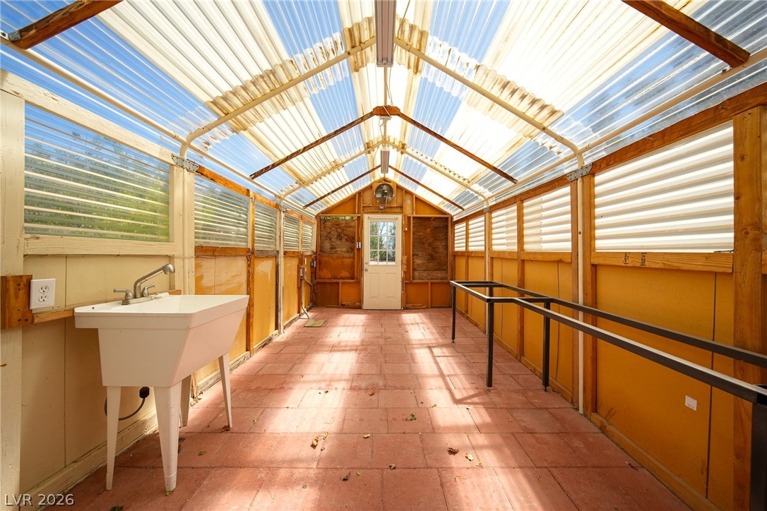 1831 West Horn Road Pahrump, NV 89048 - Photo 37 of 59 Cultivate your green thumb in this sun-drenched greenhouse featuring a utility sink and ample workspace.