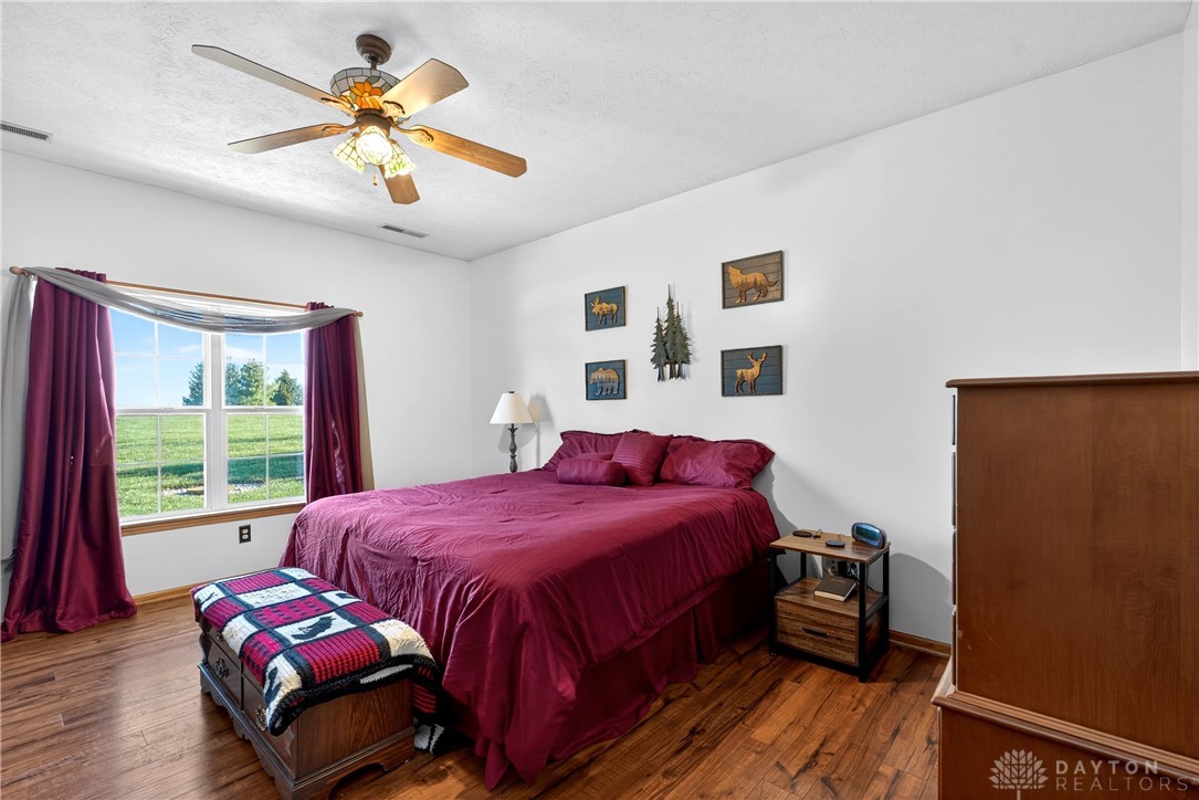 6560 Snyder Road Fletcher, OH 45326 - Photo 28 of 71 This private bedroom offers wood flooring and a refreshing view of the surrounding landscape.