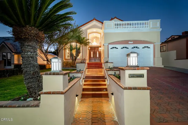 a front view of a house with a garden