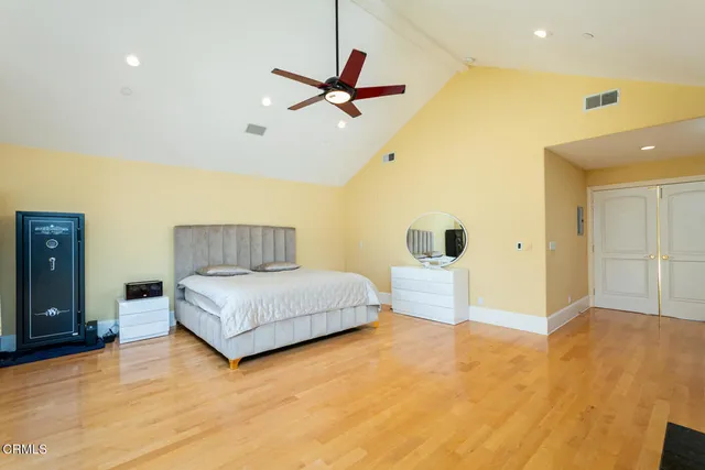 a bedroom with a bed tv and a window