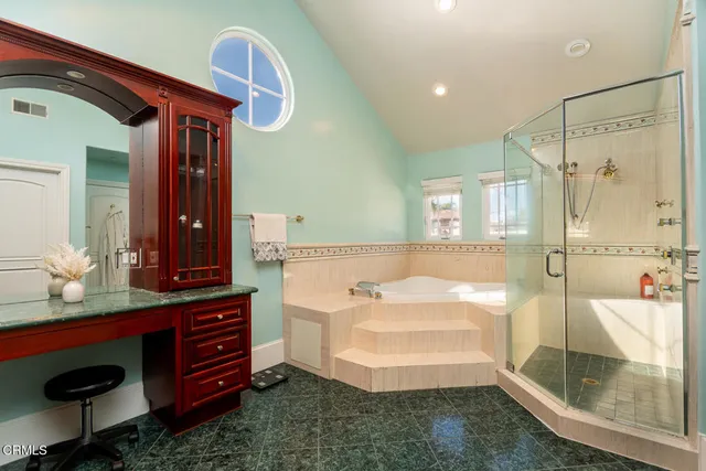 a bathroom with a sink double vanity and a shower