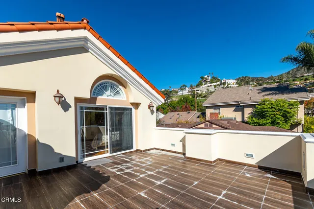 a view of a house with backyard sitting area and garden