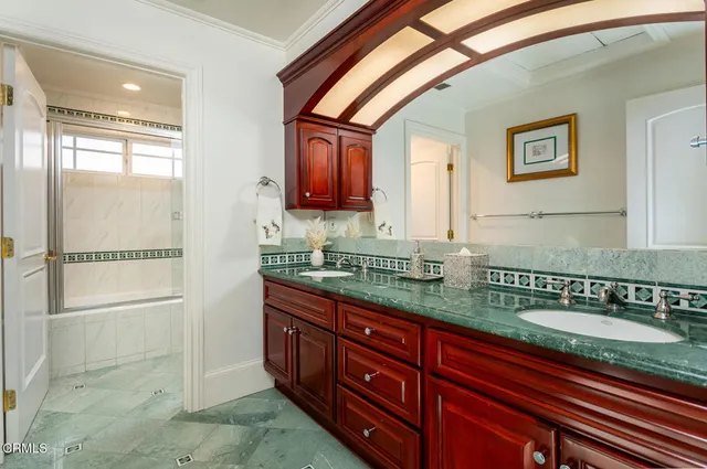 a kitchen with a stove and white cabinets