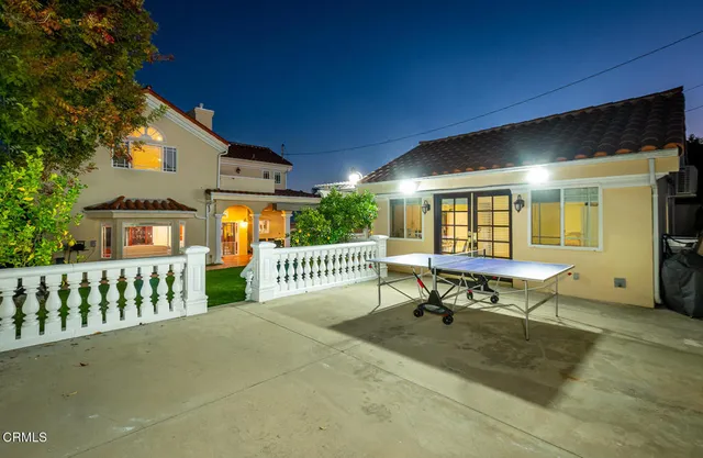 a living room with furniture a flat screen tv and a large window