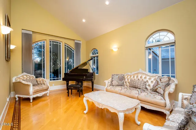 a living room with furniture and a piano