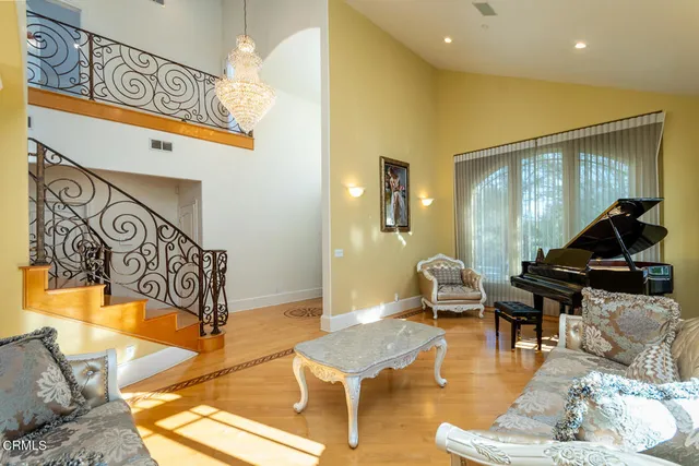 a view of a dining room with furniture and a chandelier