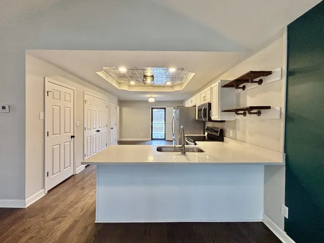a view of kitchen with furniture and wooden floor