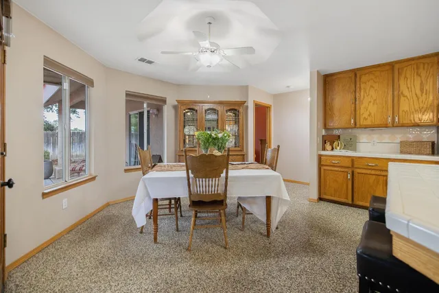 a kitchen that has a table and chairs in it
