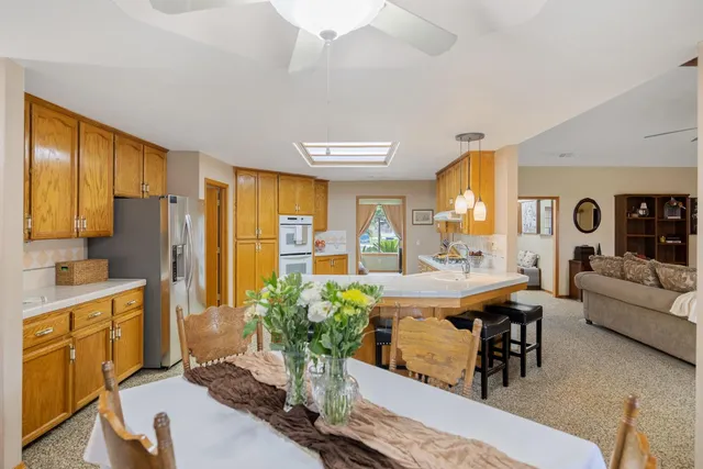 a view of an empty room with workspace and a window