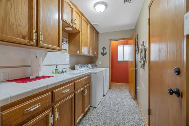 a bathroom with a tub sink shower and mirror