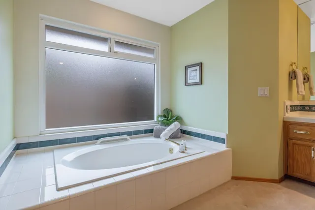 a view of a swimming pool with a table and chairs under an umbrella