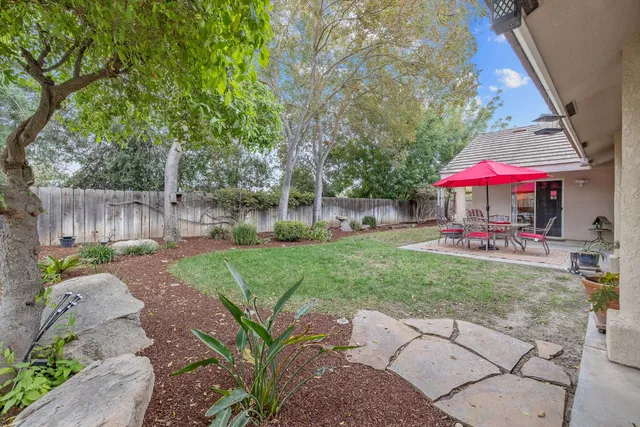 a view of a patio with a table and chairs