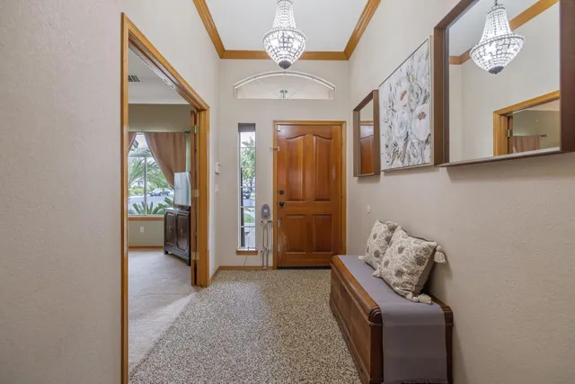 a living room with furniture a flat screen tv and a large window