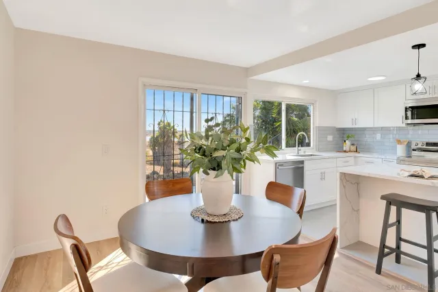 a view of a dining room with furniture and a potted plant