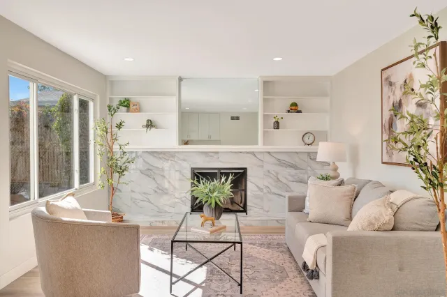 a living room with furniture and a fireplace