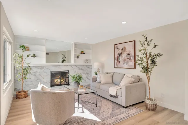 a living room with furniture and a fireplace